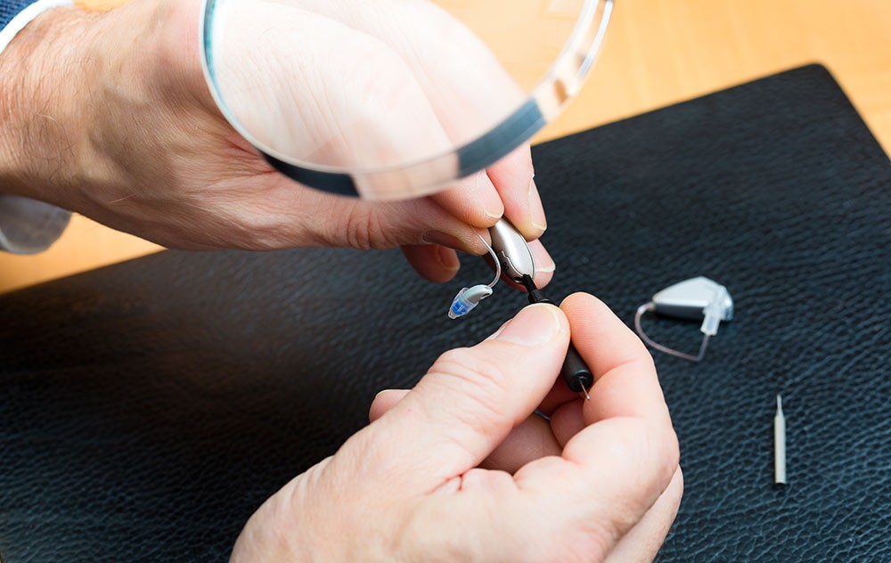 Hearing aid being repaired