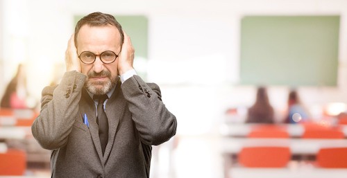 man covering ears with his hands