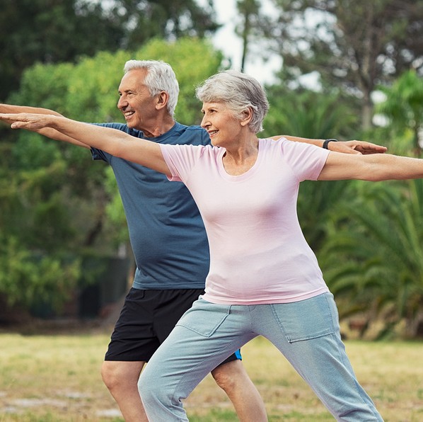 Senior couple doing physical exercises outdoor