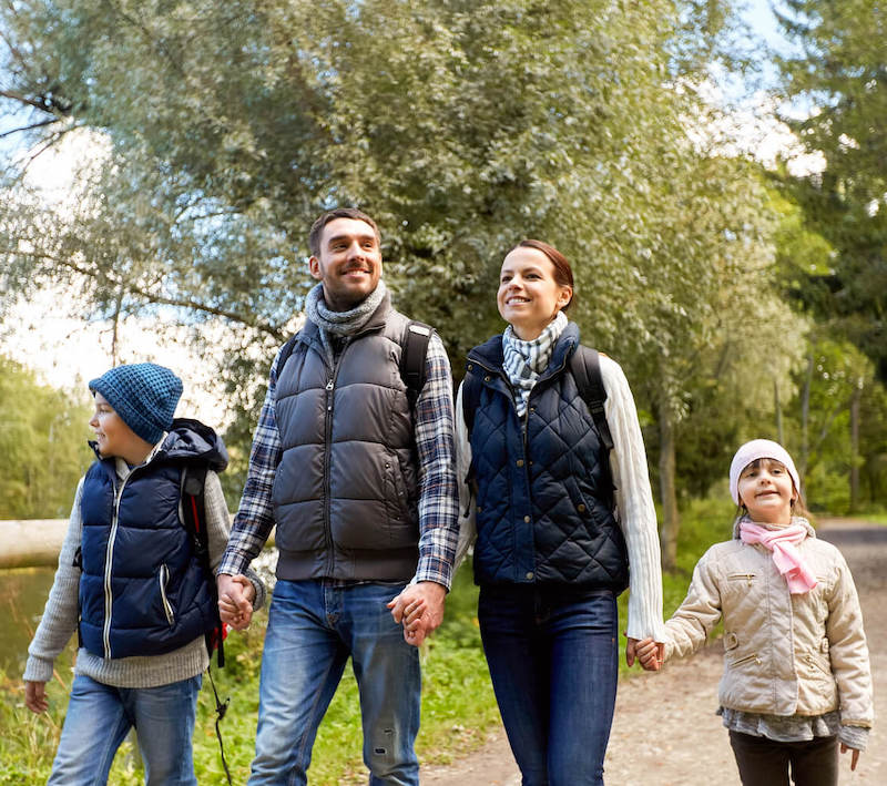 young family walking on a trail